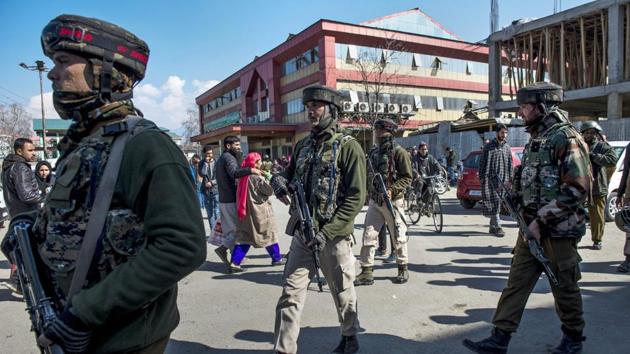 Security personnel stand guard during a search operation after an LeT terrorist escaped from police custody during a health check up at SMHS hospital, in Srinagar on Tuesday. (PTI Photo) Security personnel stand guard during a search operation after an LeT terrorist escaped from police custody during a health check up at SMHS hospital, in Srinagar on Tuesday. (PTI Photo)