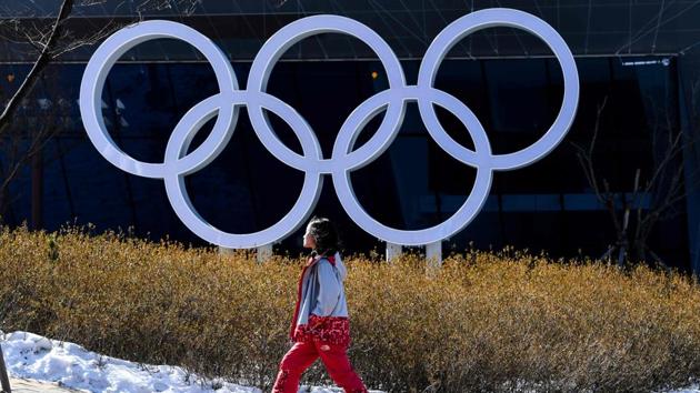 A volunteer walks past the Olympic Rings before the PyeongChang Winter Olympic Games. (AFP) A volunteer walks past the Olympic Rings before the PyeongChang Winter Olympic Games. (AFP)
