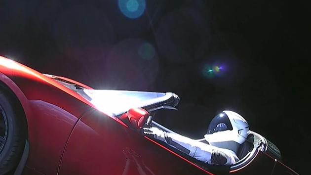 This still image taken from a SpaceX livestream video shows "Starman" sitting in SpaceX CEO Elon Musk's cherry red Tesla roadster after the Falcon Heavy rocket delivered it into orbit around the Earth on February 2, 2018.(AFP)
