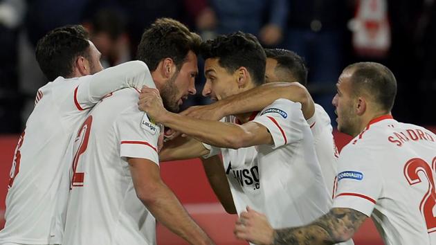 Sevilla's Italian midfielder Franco Vazquez (2L) celebrates with teammates after scoring a goal during the Spanish 'Copa del Rey' (King's cup) second leg semi-final football match against Club Deportivo Leganes.(AFP)