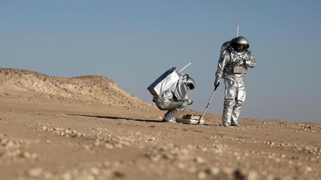 Two scientists in spacesuits, stark white against the auburn dunes, test a geo-radar built to map Mars by dragging a flat box across the rocky sand. But this isn’t the red planet — it’s the Arabian Peninsula. The desolate Dhofar desert in southern Oman resembles Mars so much that more than 200 scientists from 25 nations chose it as their location for the next four weeks, to field-test technology for a manned mission to Mars. (Karim Sahib / AFP) Two scientists in spacesuits, stark white against the auburn dunes, test a geo-radar built to map Mars by dragging a flat box across the rocky sand. But this isn’t the red planet — it’s the Arabian Peninsula. The desolate Dhofar desert in southern Oman resembles Mars so much that more than 200 scientists from 25 nations chose it as their location for the next four weeks, to field-test technology for a manned mission to Mars. (Karim Sahib / AFP)