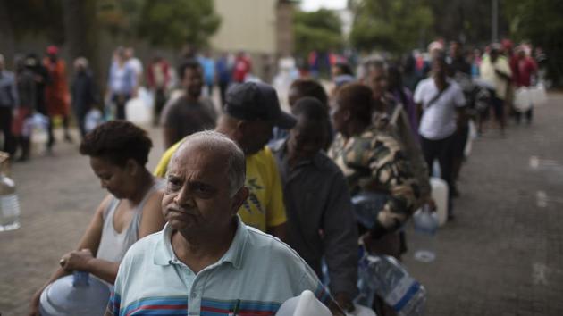 Residents wait in a queue to fill containers with water at a source for natural spring water in Cape Town South Africa on February 02, 2018. The drought-hit city of Cape Town introduced new water restrictions this week in an attempt to avoid what it calls “Day Zero,” a day in May when it might have to turn off most taps. Residents have now been asked to use no more than 50 liters of water daily. (Bram Janssen / AP) Residents wait in a queue to fill containers with water at a source for natural spring water in Cape Town South Africa on February 02, 2018. The drought-hit city of Cape Town introduced new water restrictions this week in an attempt to avoid what it calls “Day Zero,” a day in May when it might have to turn off most taps. Residents have now been asked to use no more than 50 liters of water daily. (Bram Janssen / AP)