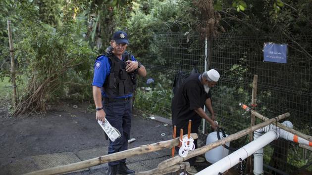 After an arrest over water sharing last week, police are guarding some natural springs to avoid any scuffles over access to the increasingly precious liquid. (Bram Janssen / AP) After an arrest over water sharing last week, police are guarding some natural springs to avoid any scuffles over access to the increasingly precious liquid. (Bram Janssen / AP)