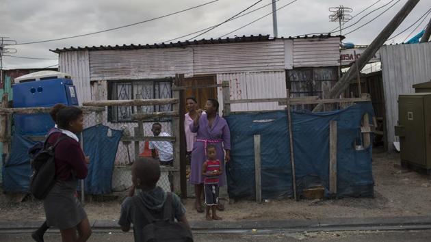 A woman brushes her teeth in an informal settlement near Cape Town. The use of city drinking water to wash vehicles, hose down paved areas, fill up private swimming pools and water gardens is illegal. Residents using too much water also risk being fined. (Bram Janssen / AP) A woman brushes her teeth in an informal settlement near Cape Town. The use of city drinking water to wash vehicles, hose down paved areas, fill up private swimming pools and water gardens is illegal. Residents using too much water also risk being fined. (Bram Janssen / AP)