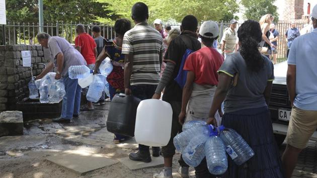 Residents queue for water at a natural spring. Some 70% of water used in Cape Town is consumed in homes, authorities say. Experts have said causes of the city’s water shortages include climate change and huge population growth. (Bram Janssen / AP) Residents queue for water at a natural spring. Some 70% of water used in Cape Town is consumed in homes, authorities say. Experts have said causes of the city’s water shortages include climate change and huge population growth. (Bram Janssen / AP)