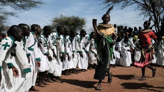 Chepureto Lobul (2R), a former cutter in the Pokot tribe performs before a meeting with journalists in Katabok village. According to UNFPA, the prevalence of FGM among Pokot women in Amudat is particularly high, compared with around half of girls and women in the Sabiny, Kadam and Tepeth communities. (Yasuyoshi Chiba / AFP) 