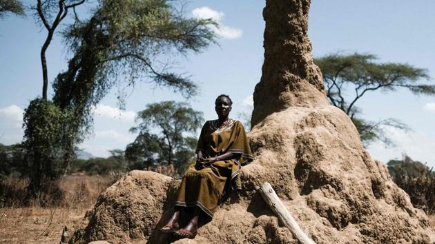 Mary Kiza, an activist against FGM, poses next to an anthill after a meeting of anti-FGM group PERUR in Alakas village. In neighbouring Kenya, around a fifth of women aged 15 to 49 have been cut, down from 38% in 1998, according to national data. Education was key to debunking myths which shore up the practice -- uncut women are forbidden from picking vegetables or collecting water for fear they will kill crops or dry up rivers. (Yasuyoshi Chiba / AFP) 