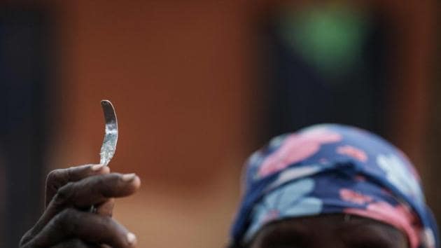 Monica Cheptilak, a 70-year-old who performed FGM for half a century, shows a home-made tool from a nail used for FGM, during an anti-FGM women’s group meet in Alakas village. Despite Uganda’s ban, the practice continues in some rural communities near the porous border with Kenya, where it is a tradition with deep roots and signals a girl’s readiness for marriage. (Yasuyoshi Chiba / AFP) 