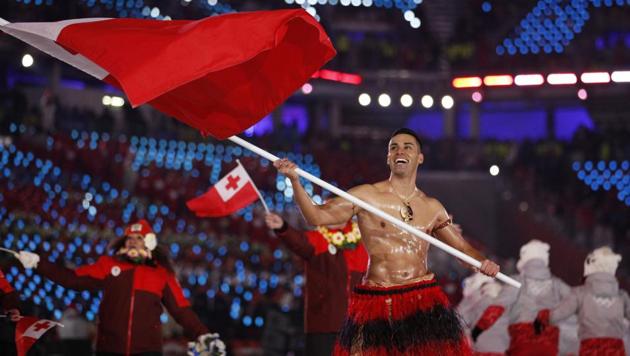 Pita Taufatofua carries the flag of Tonga during the opening ceremony of the 2018 Winter Olympics in Pyeongchang, South Korea, Friday.(AP)