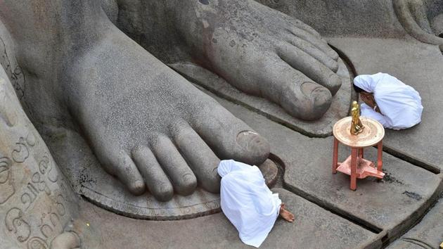 Devotees offer prayers near the 57-foot-high monolithic Gomateshwara statue on Vindyagiri in Shravanabelagola on February 7, 2018. Thousands of Jain devotees will attend the Mahamastakabhisheka on February 17. (Shailendra Bhojak / PTI) Devotees offer prayers near the 57-foot-high monolithic Gomateshwara statue on Vindyagiri in Shravanabelagola on February 7, 2018. Thousands of Jain devotees will attend the Mahamastakabhisheka on February 17. (Shailendra Bhojak / PTI)