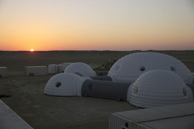 Seen from space, the Dhofar Desert is a flat, brown expanse. Few animals or plants survive here and temperatures can top 51 degrees Celsius. On the eastern edge of a seemingly endless dune is the Oman Mars Base: a giant 2.4-ton inflated habitat surrounded by shipping containers turned into labs and crew quarters. (Sam McNeil / AP) Seen from space, the Dhofar Desert is a flat, brown expanse. Few animals or plants survive here and temperatures can top 51 degrees Celsius. On the eastern edge of a seemingly endless dune is the Oman Mars Base: a giant 2.4-ton inflated habitat surrounded by shipping containers turned into labs and crew quarters. (Sam McNeil / AP)