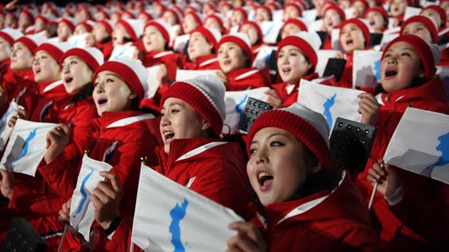 North Korean athletes sing and hold the unification flag depicting a unified Korean peninsula. (NYT) North Korean athletes sing and hold the unification flag depicting a unified Korean peninsula. (NYT)