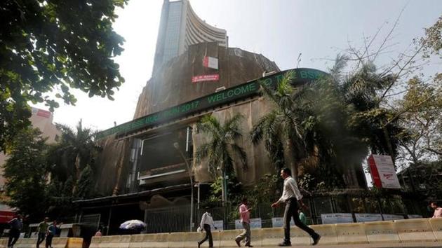 People walk past the Bombay Stock Exchange (BSE) building in Mumbai. (Reuters File Photo) People walk past the Bombay Stock Exchange (BSE) building in Mumbai. (Reuters File Photo)