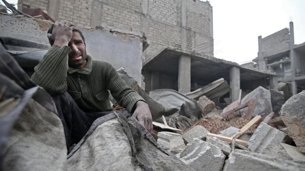 A Syrian man mourns over his destroyed home in the rebel-held besieged town of Arbin, in the eastern Ghouta region following airstrikes on the outskirts of Damascus on February 5, 2018. (Abdulmonam Eassa / AFP) A Syrian man mourns over his destroyed home in the rebel-held besieged town of Arbin, in the eastern Ghouta region following airstrikes on the outskirts of Damascus on February 5, 2018. (Abdulmonam Eassa / AFP)