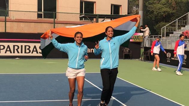 Ankita Raina (L) and Karman Kaur Thandi celebrate after winning against Chinese Taipei in the Fed Cup on Saturday. (Karman Kaur Thandi/Twitter) Ankita Raina (L) and Karman Kaur Thandi celebrate after winning against Chinese Taipei in the Fed Cup on Saturday. (Karman Kaur Thandi/Twitter)