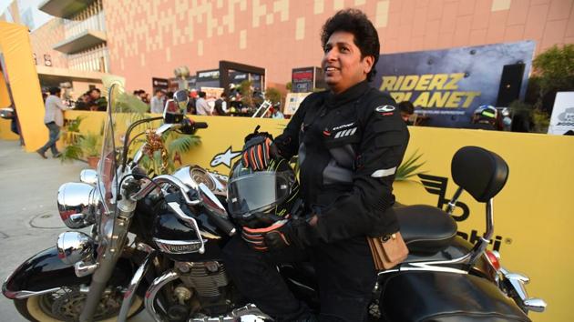 Biker Dinesh Gupta has been riding his Triumph cruiser to the motor show every day to make visitors aware of road safety.(Virendra Singh Gosain/HT PHOTO)