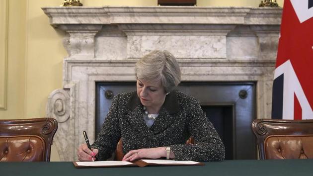 Britain's Prime Minister Theresa May signs the official letter to European Council President Donald Tusk, in 10 Downing Street, London, Tuesday March 28, 2017, invoking Article 50 of the bloc's key treaty, the formal start of Brexit negotiations. (AP File) Britain's Prime Minister Theresa May signs the official letter to European Council President Donald Tusk, in 10 Downing Street, London, Tuesday March 28, 2017, invoking Article 50 of the bloc's key treaty, the formal start of Brexit negotiations. (AP File)