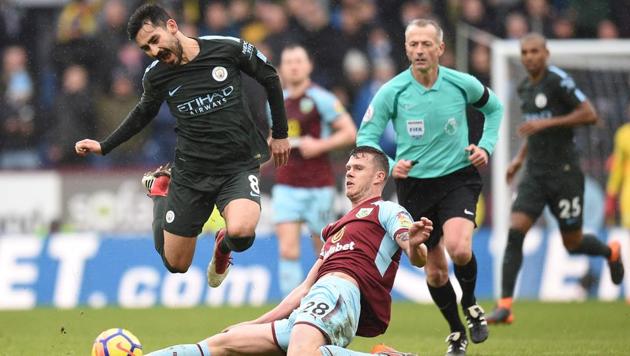 Burnley defender Kevin Long slides into a tackle on Manchester City's Ilkay Gundogan (L) for which he receives a yellow card during the English Premier League football match between Burnley and Manchester City at Turf Moor in Burnley on February 3, 2018. Manchester City would like to see a change in Football Association (FA) rules that would allow incidents seen by referees on the field during Premier League games to be reviewed again retrospectively. (AFP) Burnley defender Kevin Long slides into a tackle on Manchester City's Ilkay Gundogan (L) for which he receives a yellow card during the English Premier League football match between Burnley and Manchester City at Turf Moor in Burnley on February 3, 2018. Manchester City would like to see a change in Football Association (FA) rules that would allow incidents seen by referees on the field during Premier League games to be reviewed again retrospectively. (AFP)