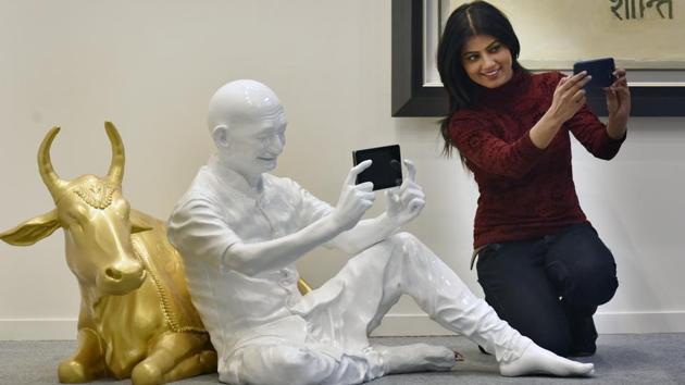 A visitor takes a picture with “Gandhi Taking Selfie with Cow” by Debanjan Roy. The four day programme - which draws together galleries and artists, private foundations and arts charities, artists’ collectives, national institutions, cultural events and festivals - enables international audiences to engage in with the cultural history and development of the region. (Raj K Raj / HT Photo) A visitor takes a picture with “Gandhi Taking Selfie with Cow” by Debanjan Roy. The four day programme - which draws together galleries and artists, private foundations and arts charities, artists’ collectives, national institutions, cultural events and festivals - enables international audiences to engage in with the cultural history and development of the region. (Raj K Raj / HT Photo)