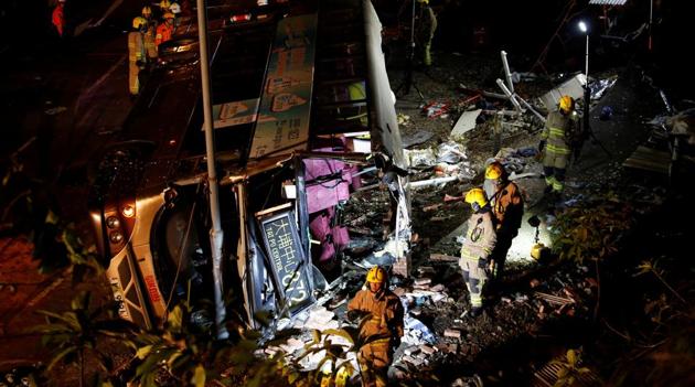 Rescuers walk beside a crashed bus in Hong Kong, China on Saturday.(Reuters Photo)
