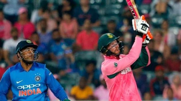 South Africa cricket team's batsman Heinrich Klaasen (right) hits a boundary as India cricket team wicketkeeper MS Dhoni during the 4th ODI (Pink ODI) at the Wanderers Stadium in Johannesburg on Saturday.(AFP)