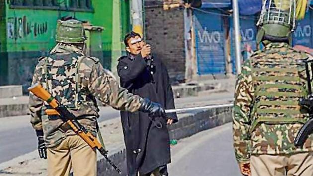 Security forces stop a pedestrian in Srinagar, where restrictions were imposed on Friday. (AP File Photo) Security forces stop a pedestrian in Srinagar, where restrictions were imposed on Friday. (AP File Photo)