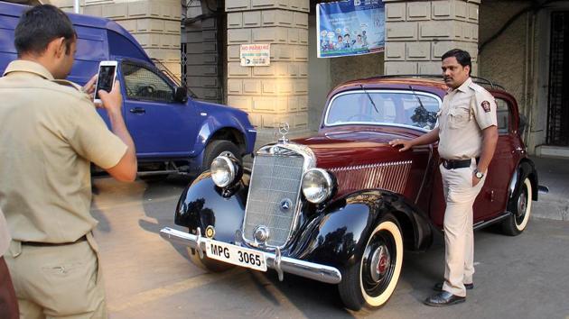 A policeman strikes a pose with a classic Mercedes-Benz on Sunday. (Pramod Thakur/HT Photo)