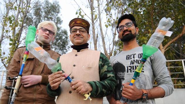 Professor Samrat Ghosh and his students show the prototype of ‘smokeless smart crackers’ in Mohali on Sunday.(Ravi Kumar/HT Photo)