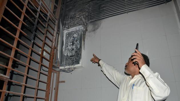 A man shows the electric box at civil hospital where the fire broke out. (Praful Gangurde/HT) A man shows the electric box at civil hospital where the fire broke out. (Praful Gangurde/HT)