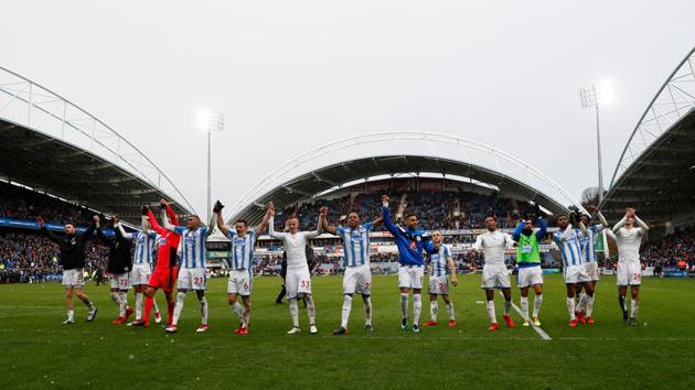 Huddersfield Town’s Jonathan Hogg and teammates celebrate in front of the fans at the end of the match against Bournemouth in the Premier League on Sunday.(Reuters)