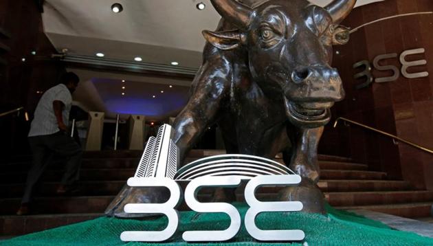 The Bombay Stock Exchange (BSE) logo is seen under a bull statue at the entrance of their building in Mumbai, India(REUTERS)