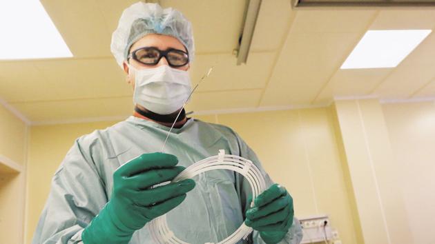Dmitry Stolyarov, a heart surgeon, holds a stent.(REUTERS File Photo)