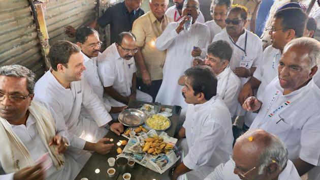 Congress President Rahul Gandhi, along with Karnataka chief minister Siddaramaiah and party leaders has ‘Mirchi Bajji’, a local ‘pakora’ snack, along with tea at Kalamala, 16 kms from Raichur on Monday.(PTI Photo)