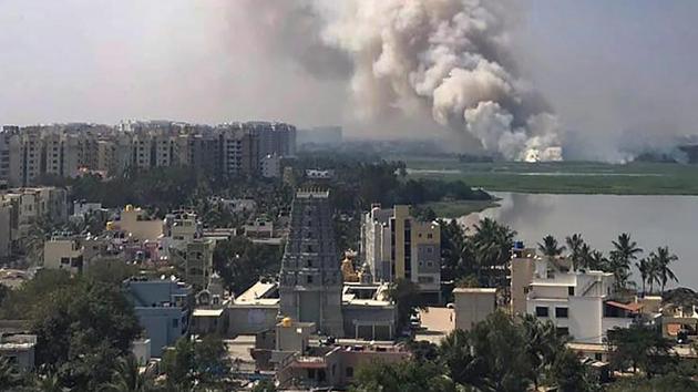 Bengaluru: Smoke billows from a fire in middle of the wetlands of the severely-polluted Bellandur lake, in Bengaluru on Friday. PTI Photo (PTI1_19_2018_000216B) (PTI) Bengaluru: Smoke billows from a fire in middle of the wetlands of the severely-polluted Bellandur lake, in Bengaluru on Friday. PTI Photo (PTI1_19_2018_000216B) (PTI)
