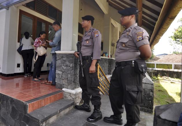 Police officers stand guard outside the St Lidwina Church following the attack on Sunday.(AP)
