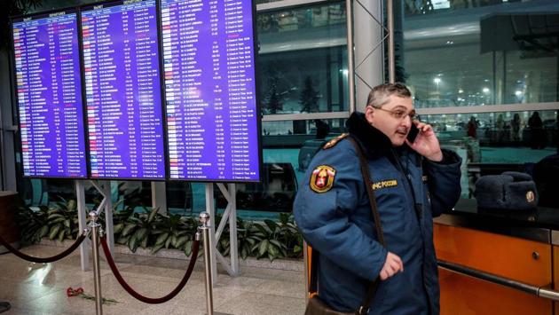 A Russian emergency employee stands next to flowers placed in tribute to the plane crash victims under of the flight schedule timetables at the Domodedovo International Airport. President Vladimir Putin has ordered a special commission to investigate the crash. (Maxim Zmeyev / AFP) A Russian emergency employee stands next to flowers placed in tribute to the plane crash victims under of the flight schedule timetables at the Domodedovo International Airport. President Vladimir Putin has ordered a special commission to investigate the crash. (Maxim Zmeyev / AFP)
