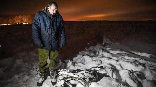 A man looks at debris at the site of the crash on the outskirts of Moscow. Russia’s Investigative Committee said it would consider explanations for the crash including human error, technical failure and weather conditions, as the country has experienced record snowfall in recent weeks. It did not mention the possibility of terrorism. (Vasily Maximov / AFP) A man looks at debris at the site of the crash on the outskirts of Moscow. Russia’s Investigative Committee said it would consider explanations for the crash including human error, technical failure and weather conditions, as the country has experienced record snowfall in recent weeks. It did not mention the possibility of terrorism. (Vasily Maximov / AFP)
