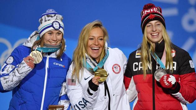 USA’s Jamie Anderson (C) created history on Monday when she became the first woman in history to win win more than one gold medal in Olympic snowboarding. (AFP)