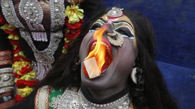 A man dressed as the goddess Kali performs a fire act during a procession to mark Mahashivratri in Allahabad. Mahashivratri is considered among varying versions, the night of Shiva and Parvati’s marriage. Devotees mark the occasion with all-night vigils, singing hymns and offering prayers to Shiva. (Rajesh Kumar Singh / AP)