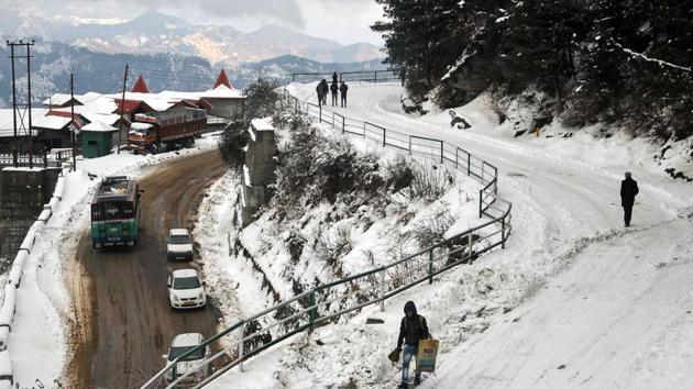 People walk on a snow-covered road on the outskirts of Shimla. “The areas are likely to witness more snowfall during next 12 hours,” said Manmohan Singh, director of the local metrological office. (AFP) People walk on a snow-covered road on the outskirts of Shimla. “The areas are likely to witness more snowfall during next 12 hours,” said Manmohan Singh, director of the local metrological office. (AFP)