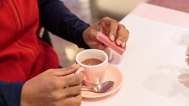 A tourist from Australia tastes a ruby hot chocolate as she holds a rubi Kitkat bar at a KitKat chocolatory shop in Tokyo. (AFP) A tourist from Australia tastes a ruby hot chocolate as she holds a rubi Kitkat bar at a KitKat chocolatory shop in Tokyo. (AFP)