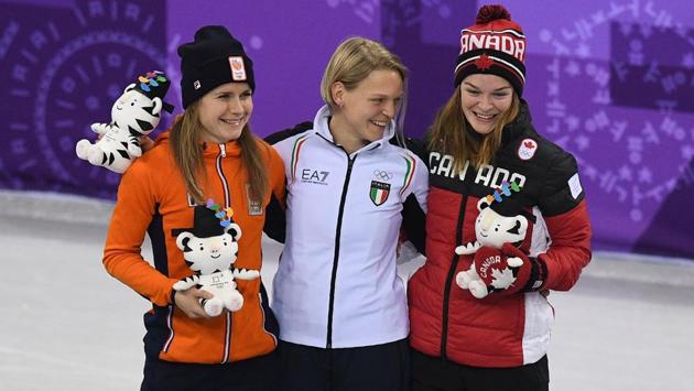 (L-R) Silver medallist Netherlands' Yara van Kerkhof, gold medallist Italy's Arianna Fontana and bronze medallist Canada's Kim Boutin celebrate on the podium after the women's 500m short track speed skating event during the Pyeongchang 2018 Winter Olympic Games, at the Gangneung Ice Arena in Gangneung on February 13, 2018. (AFP) (L-R) Silver medallist Netherlands' Yara van Kerkhof, gold medallist Italy's Arianna Fontana and bronze medallist Canada's Kim Boutin celebrate on the podium after the women's 500m short track speed skating event during the Pyeongchang 2018 Winter Olympic Games, at the Gangneung Ice Arena in Gangneung on February 13, 2018. (AFP)