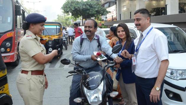 A motorist poses with the rose he was given by the Kalyan RTO officials on Wednesday. (Rishikesh Choudhary) A motorist poses with the rose he was given by the Kalyan RTO officials on Wednesday. (Rishikesh Choudhary)