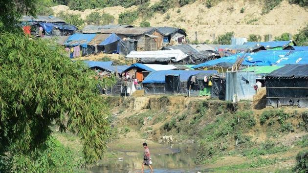 A Rohingya Muslim refugee crosses a canal next to a settlement near the 'no man's land' area between Myanmar and Bangladesh in Tombru in Bangladesh's Bandarban district. (AFP File Photo) A Rohingya Muslim refugee crosses a canal next to a settlement near the 'no man's land' area between Myanmar and Bangladesh in Tombru in Bangladesh's Bandarban district. (AFP File Photo)