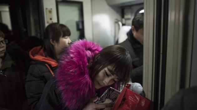 Unsure of whether they’d be returning to Beijing when the 15-day festival is over, people passed time playing on smartphones, sharing food and chatting with fellow passengers. Even the children mostly stayed quiet. The brutal efficiency of the demolitions and mass evictions over the past year has provoked an unusual public outcry that has officials on edge and residents uncertain. (Fred Dufour / AFP) Unsure of whether they’d be returning to Beijing when the 15-day festival is over, people passed time playing on smartphones, sharing food and chatting with fellow passengers. Even the children mostly stayed quiet. The brutal efficiency of the demolitions and mass evictions over the past year has provoked an unusual public outcry that has officials on edge and residents uncertain. (Fred Dufour / AFP)
