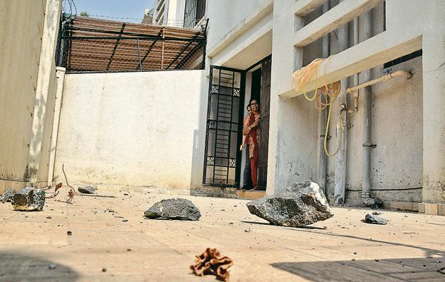 Broken shards of glass, punctured pipelines and a shower of boulders fell in many of the residents’ terraces and gardens.(HT PHOTO)