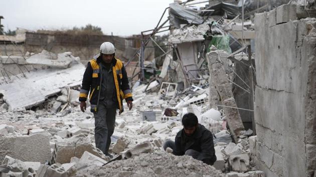 Forty-five-year-old Samir Salim (L), who along with his three brothers are members of the White Helmets rescue forces, looks at the rubble of his destroyed home in the town of Medeira in Syria's rebel-held Eastern Ghouta region on February 12, 2018. (AFP Photo) Forty-five-year-old Samir Salim (L), who along with his three brothers are members of the White Helmets rescue forces, looks at the rubble of his destroyed home in the town of Medeira in Syria's rebel-held Eastern Ghouta region on February 12, 2018. (AFP Photo)