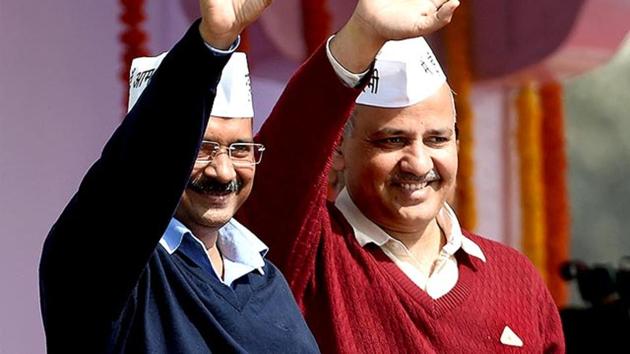 Delhi chief minister Arvind Kejriwal with his deputy, Manish Sisodia (R), greeting supporters during his swearing-in ceremony on February 14, 2015 at Ramlila Ground in New Delhi.(AFP Photo)