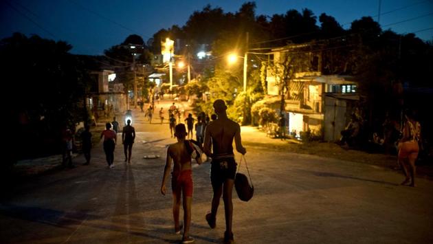Two visiting wrestlers walk back to the home that's hosting them. Heredia, who has been conducting trains for 38 years, says his dream is to one day create a professional wrestling school that can feed Cuban youths’ appetite for the sport. (Ramon Espinosa / AP) Two visiting wrestlers walk back to the home that's hosting them. Heredia, who has been conducting trains for 38 years, says his dream is to one day create a professional wrestling school that can feed Cuban youths’ appetite for the sport. (Ramon Espinosa / AP)
