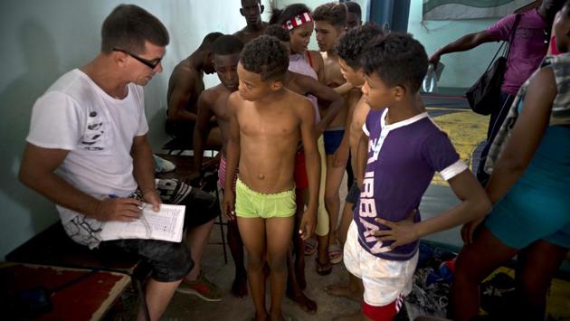 Wrestlers are weighed by an instructor during the “The truth of my neighbourhood” championship. Relatively small and short on resources, Cuba has long been an outsize power in amateur athletics, bringing back hundreds of Olympic and international medals in boxing, track and field and wrestling. (Ramon Espinosa / AP) Wrestlers are weighed by an instructor during the “The truth of my neighbourhood” championship. Relatively small and short on resources, Cuba has long been an outsize power in amateur athletics, bringing back hundreds of Olympic and international medals in boxing, track and field and wrestling. (Ramon Espinosa / AP)